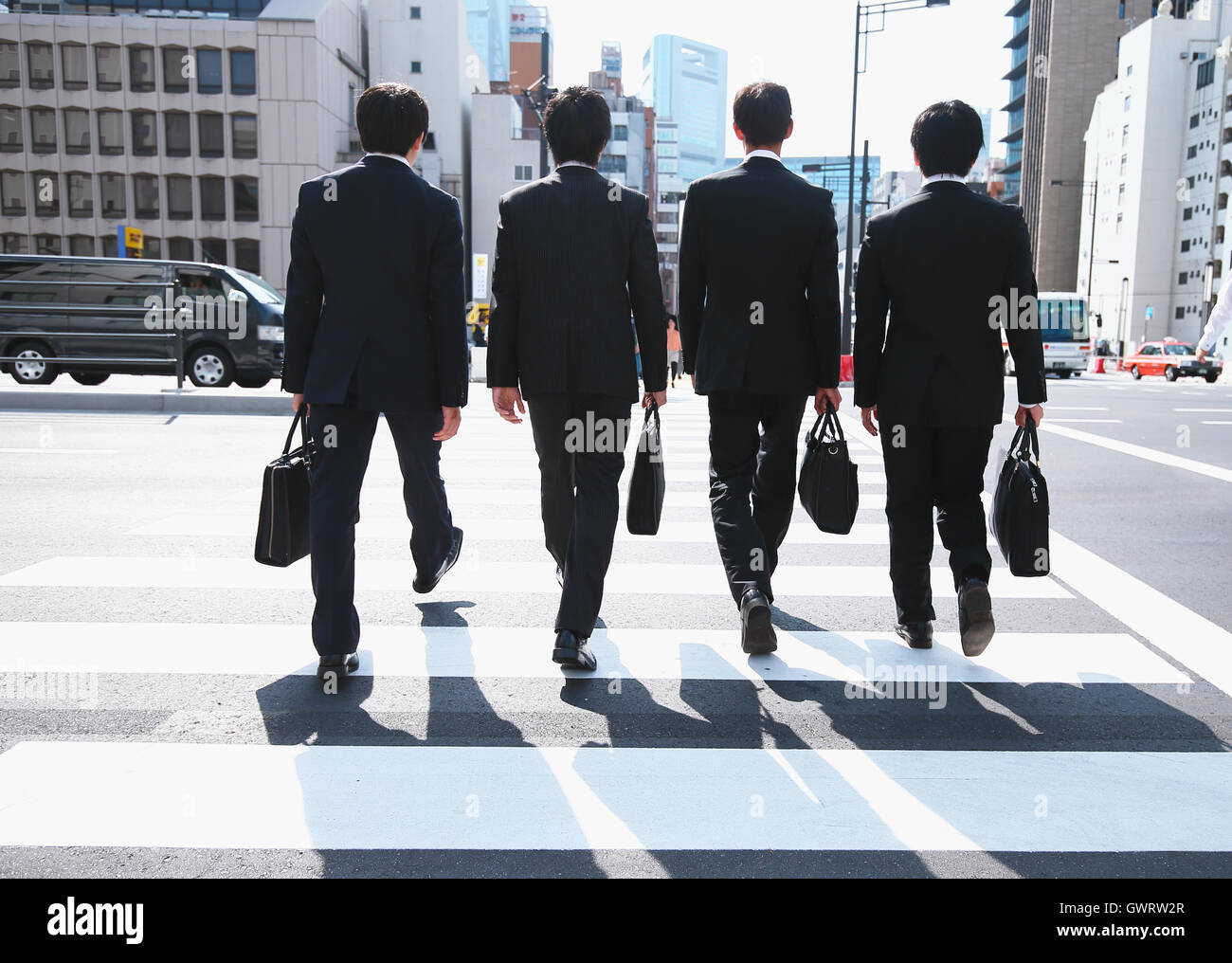Young Japanese businessmen walking Stock Photo - Alamy
