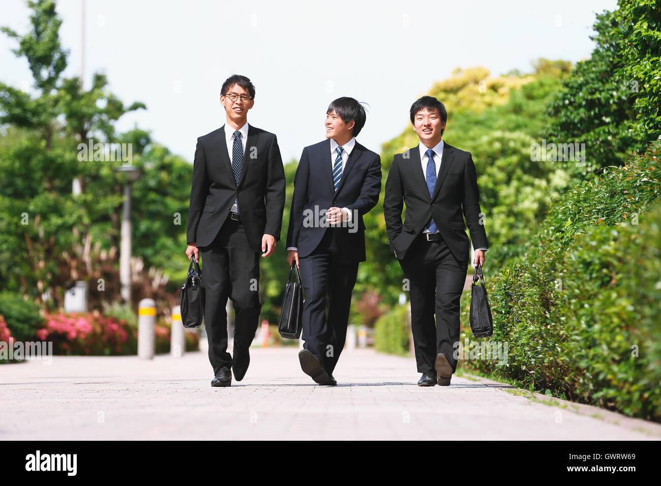 Young Japanese businessmen walking Stock Photo - Alamy