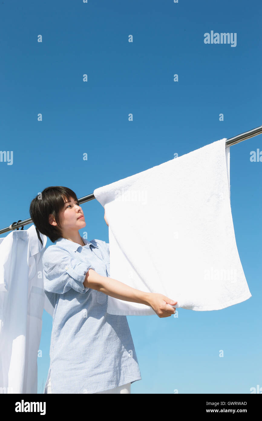 Young Japanese woman doing laundry Stock Photo Alamy