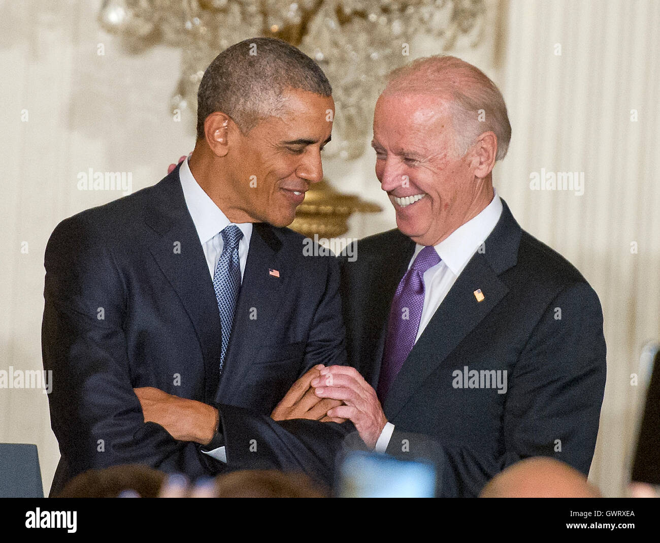 United States President Barack Obama, left, and US Vice President Joe Biden, right, share smiles as the President is introduced prior to his making remarks at a reception for the 25th Anniversary of the White House Initiative on Educational Excellence for Stock Photo