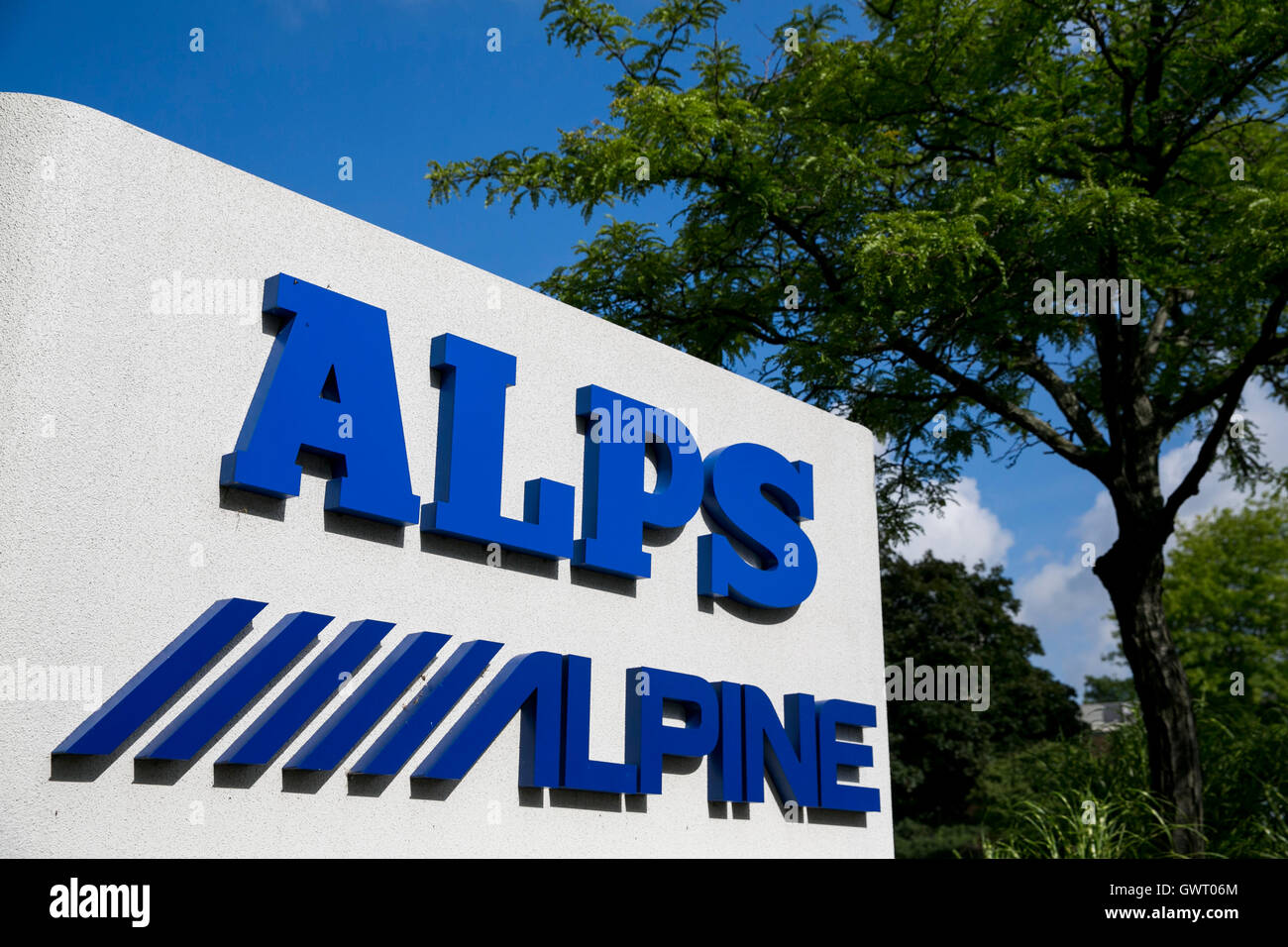 A logo sign outside of a facility occupied by Alps Electric Co., Ltd., and Alpine Electronics, Inc., in Auburn Hills, Michigan o Stock Photo