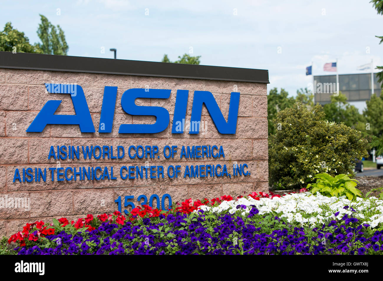 A logo sign outside of a facility occupied by Aisin Seiki Co., Ltd., in