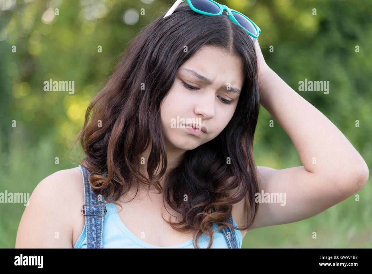Portrait of teen girl busy problems in summer nature Stock Photo