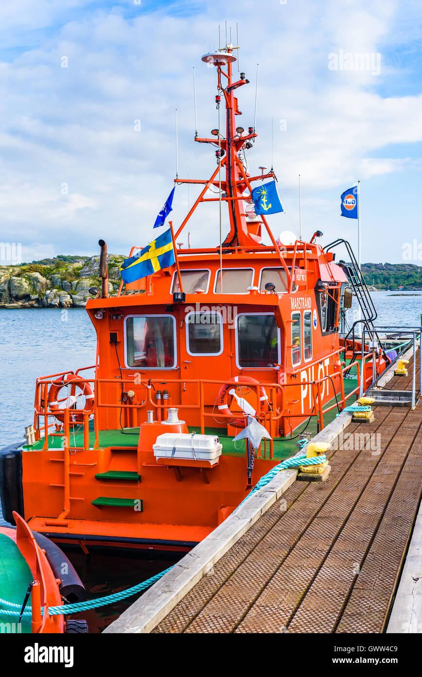 Marstrand, Sweden - September 8, 2016: Environmental documentary of red pilot boat moored in the harbor. Stock Photo