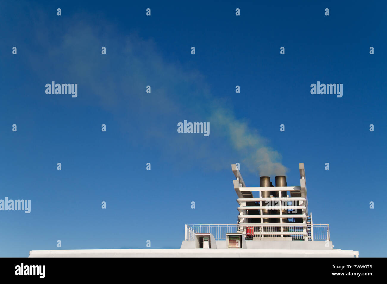 Exhaust gas from the smokestack of a ship Stock Photo