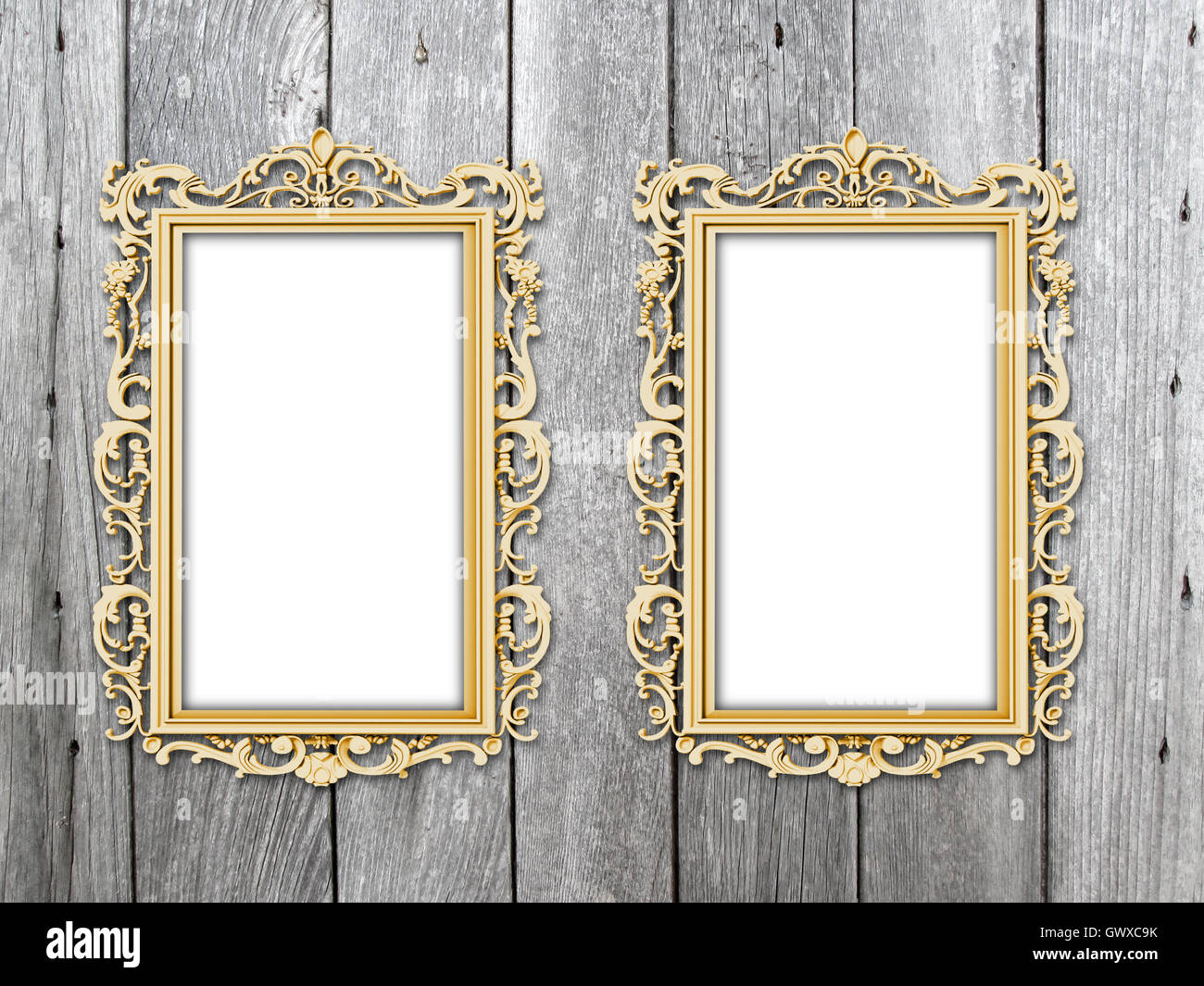 Close-up of two golden Baroque picture frames on gray weathered wooden