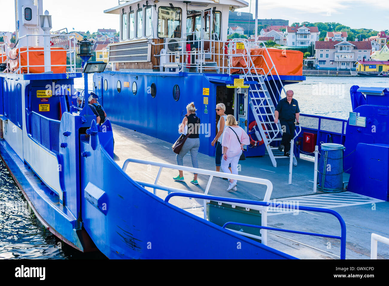 Marstrand, Sweden - September 8, 2016: Environmental documentary of people walking on the wire operated ferry to the Marstrand i Stock Photo