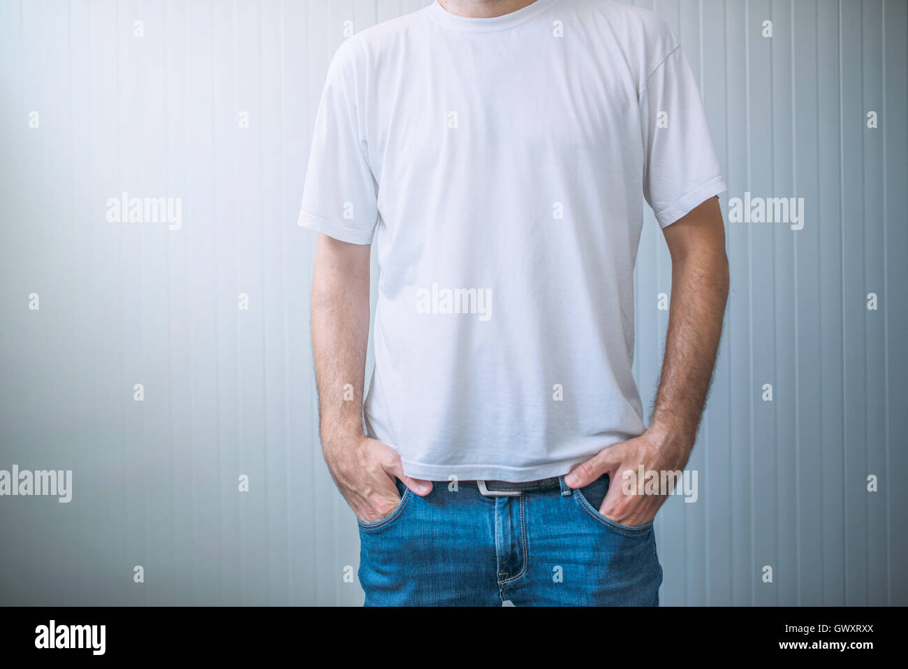 Casual adult male wearing blank white t-shirt as copy space for graphic design mock up Stock Photo