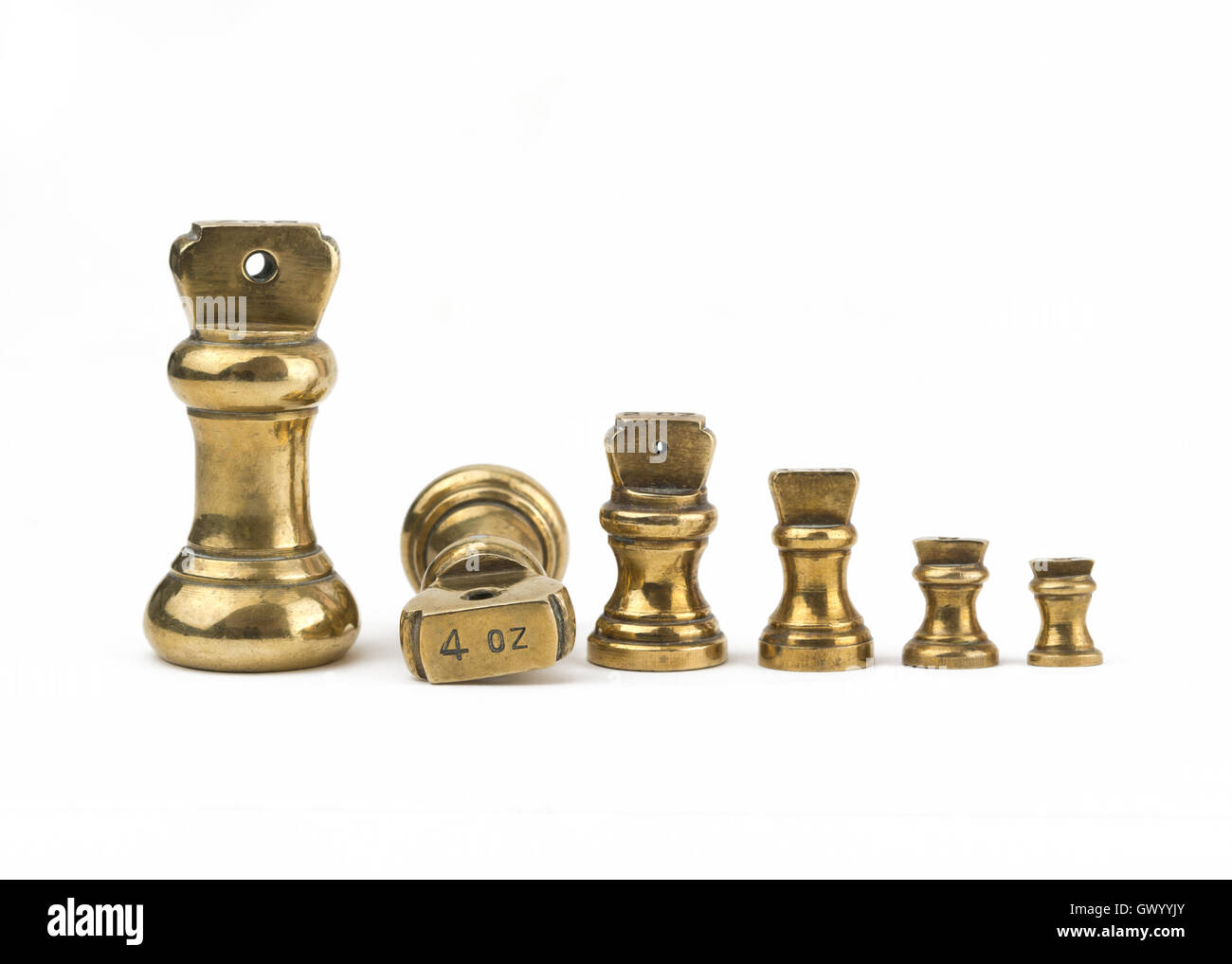 A set of antiques brass imperial weights isolated on a white background. showing 4oz Stock Photo