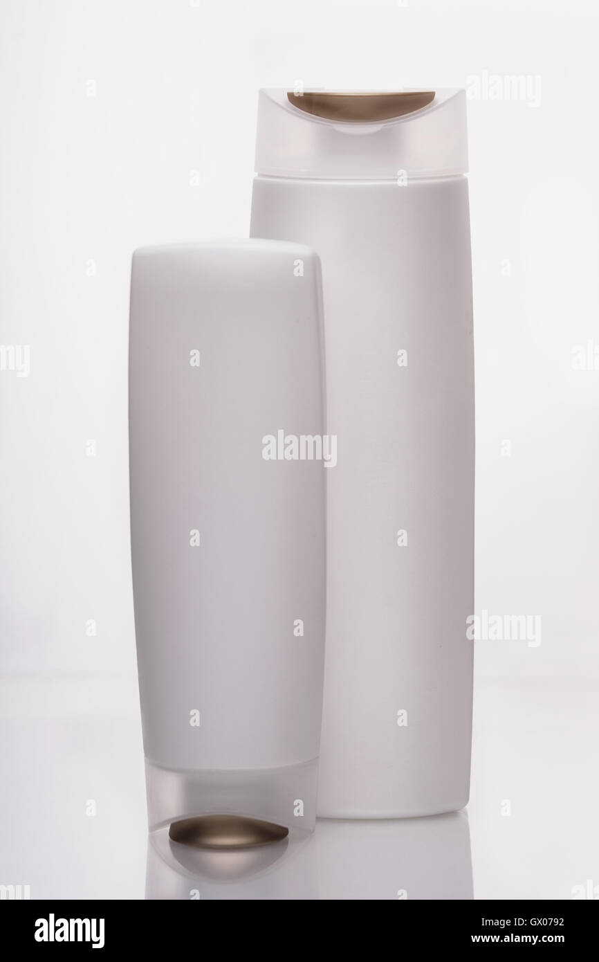 White bottles for liquids and shampoo in the bathroom, on a white