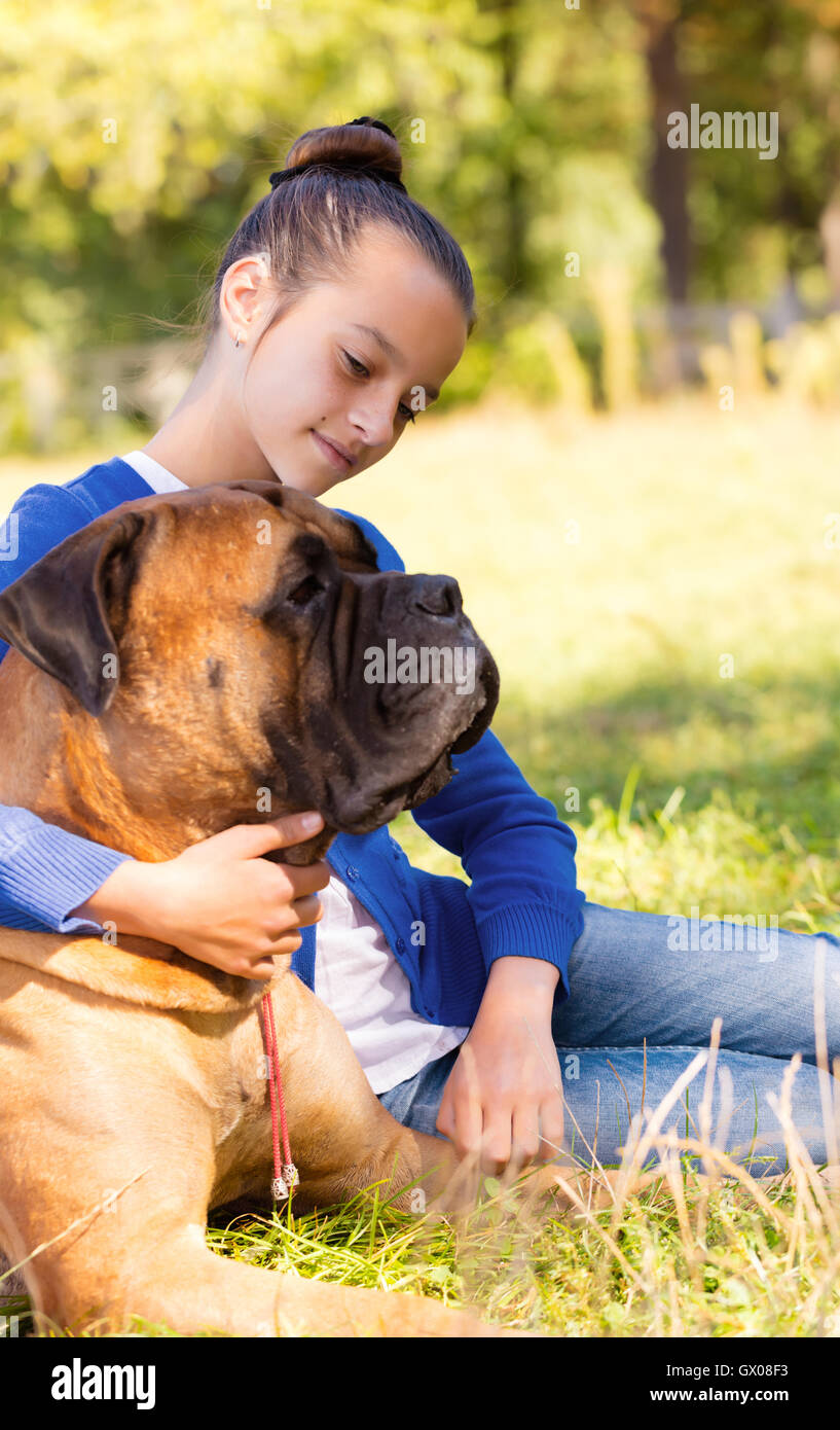 teen girl with the dog Bullmastiff outdoors Stock Photo