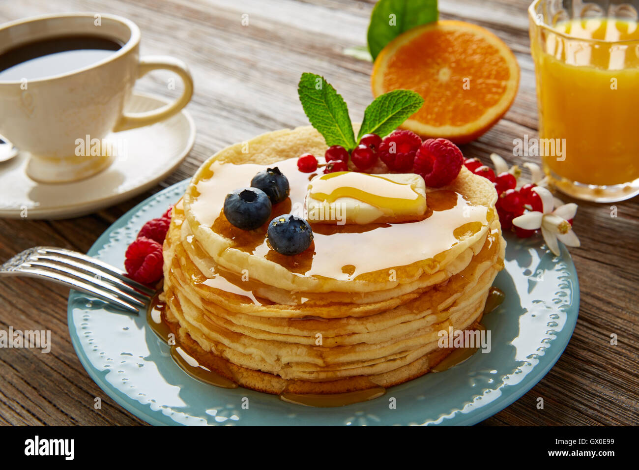 pancakes breakfast syrup coffee and orange juice with berries Stock