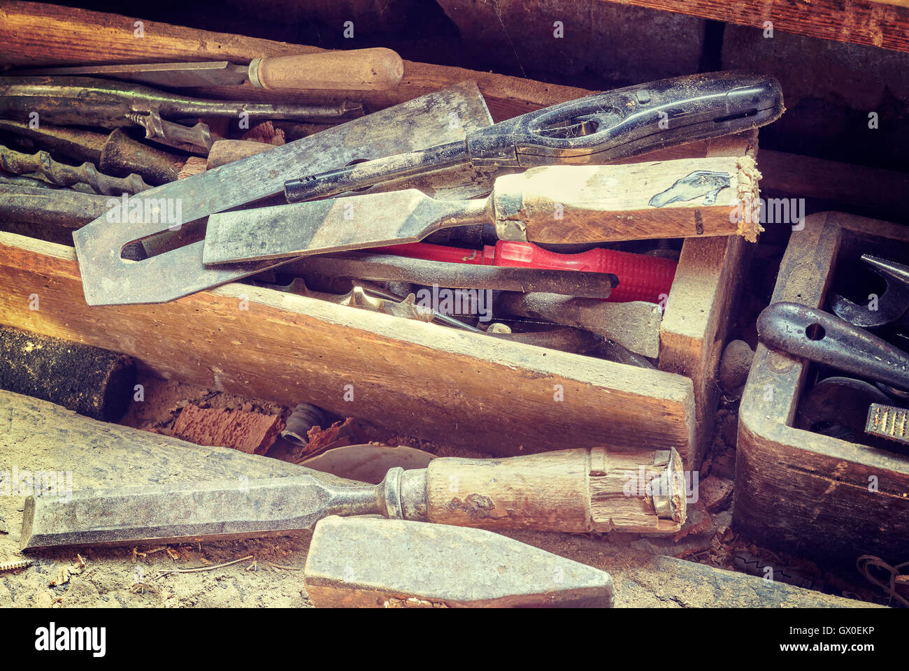 Retro toned old tools on dusty wooden table in a joinery. Stock Photo