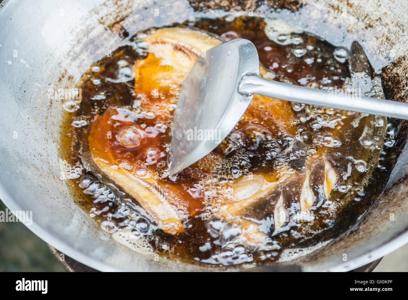 fish frying in oil on the fire Stock Photo Alamy