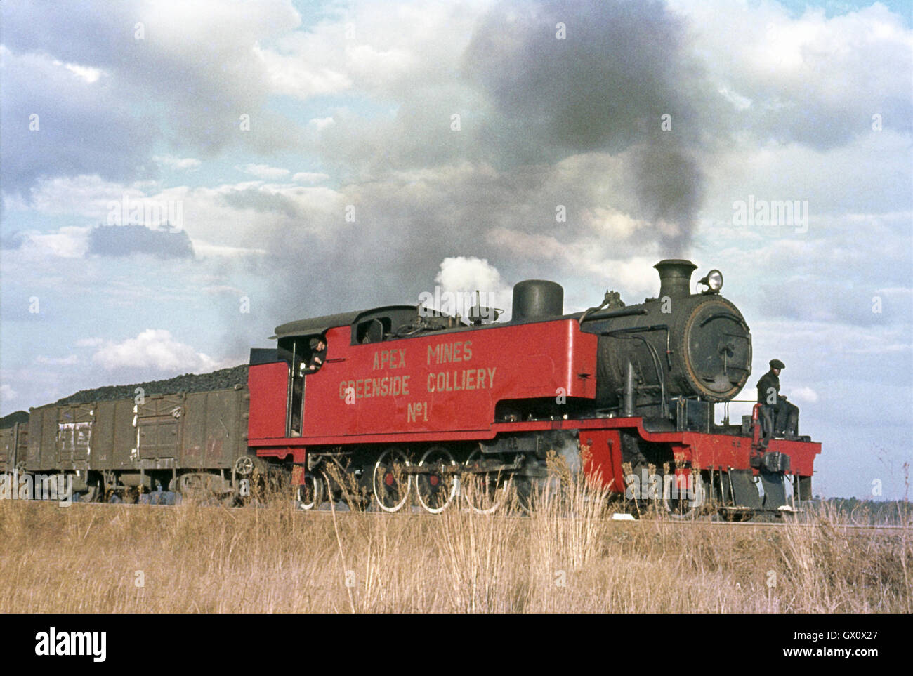A North British built 4-8-2T makes a fine contrast with the cloud flecked sky as it lifts a loaded train Stock Photo