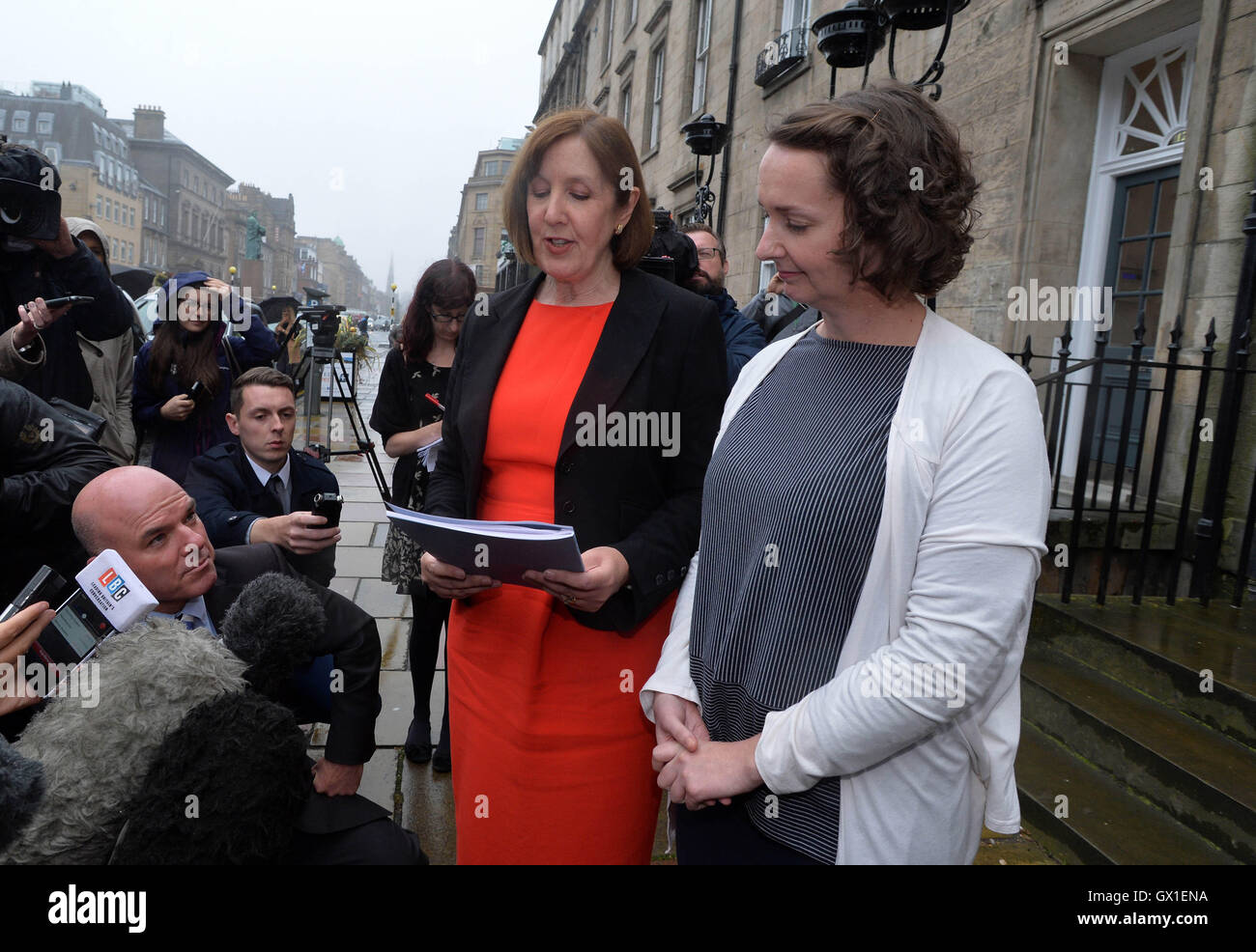 Ebola nurse Pauline Cafferkey (right) stands outside the Nursing and Midwifery Council in Edinburgh as her legal representative Joyce Cullen reads a statement after she was cleared of professional misconduct by a panel following a probe into her return to the UK with the virus. Stock Photo