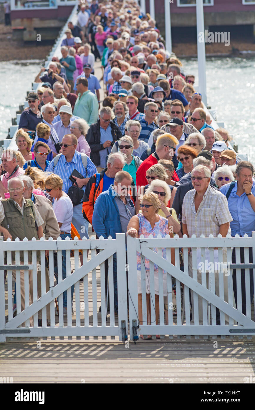 Crowds queue at Yarmouth Pier waiting for the Waverley paddle steamer to arrive for a trip around the Isle of Wight, Hampshire UK in September Stock Photo