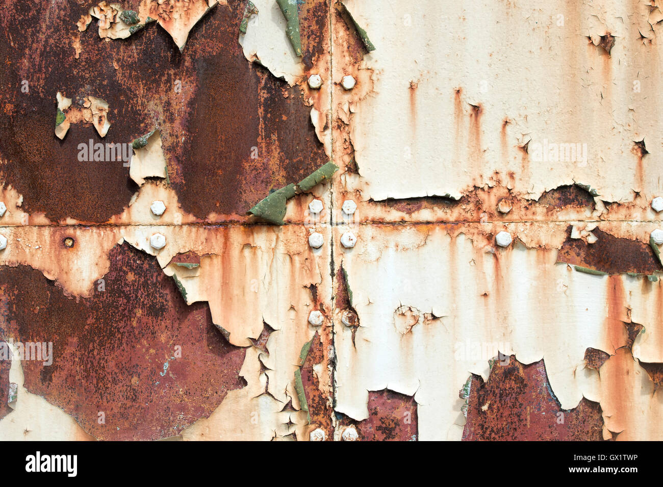 Peeling paint rust and rivets texture. Old metal garage door Stock Photo