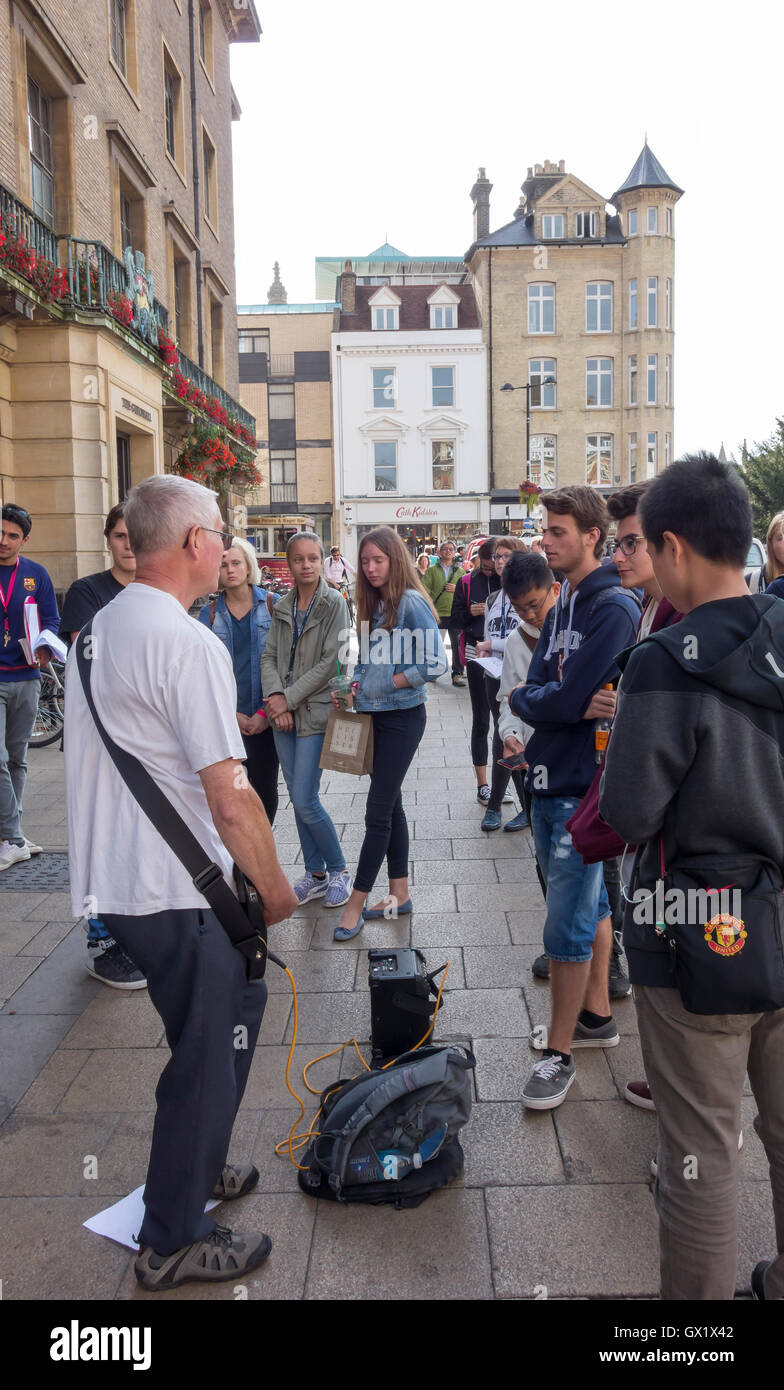 Busker talking to audience on Market Hill in front of the Guildhall Cambridge City Cambridgeshire England 2016 Stock Photo