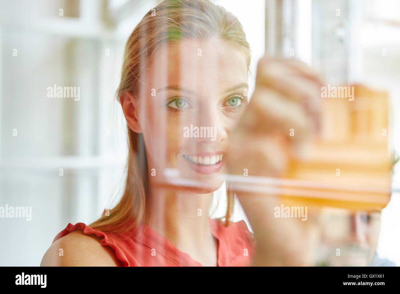 Woman as student writing ideas on sticky notes Stock Photo