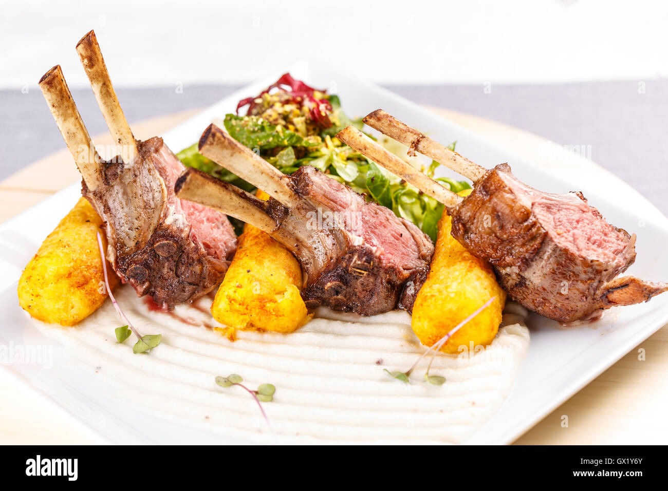 Organic grilled lamb chops with mashed potatofilled croquettes Stock Photo Alamy