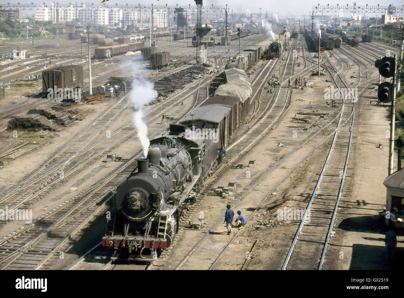A China Railway JF Class Mikado draws a heavy rake of wagons through Sankong yard prior to them being hump-shunted, August 1985. Stock Photo