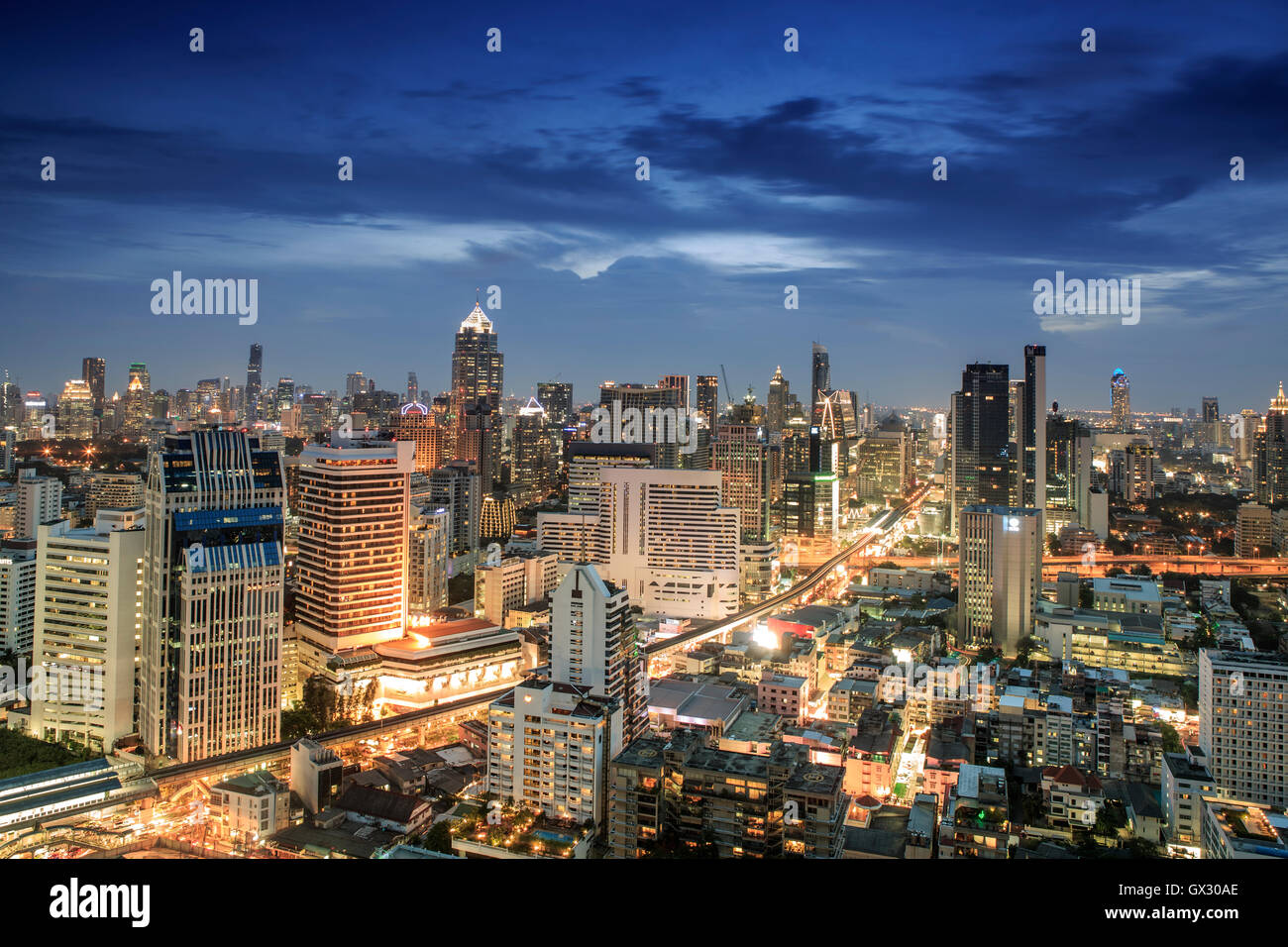 Bangkok city skyline at night - Skytrain train line & main tourist area around Sukhumvit showing Chit Lom and Phloen Chit Road, Pathum Wan District Stock Photo