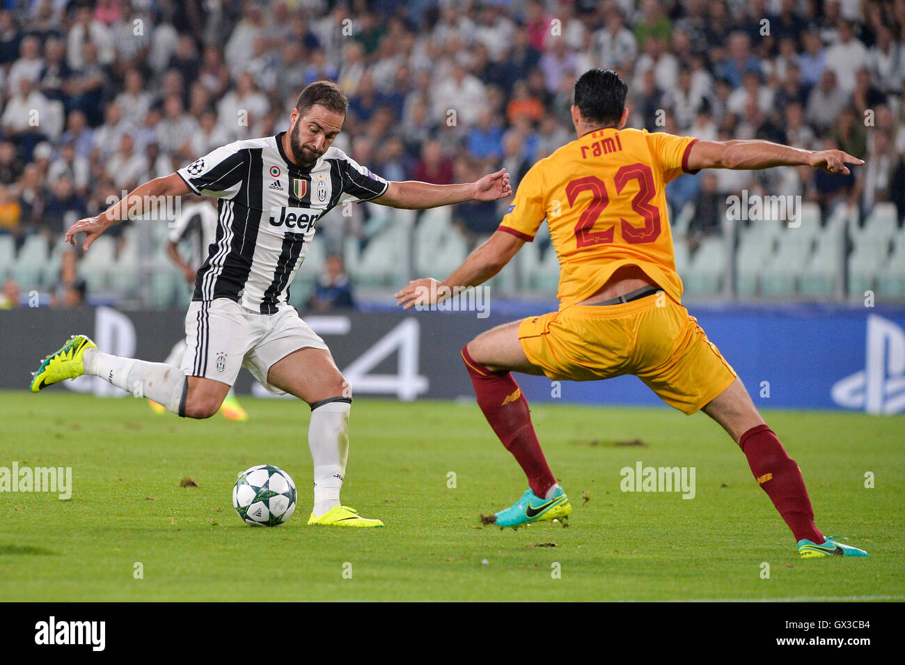 Turin, Italy. 14th Sep, 2016. Gonzalo Higuain (L) of Juventus vies with Adil Rami of Sevilla during the UEFA Champions League soccer match in Turin, Italy, Sept. 14, 2016. © Alberto Lingria/Xinhua/Alamy Live News Stock Photo