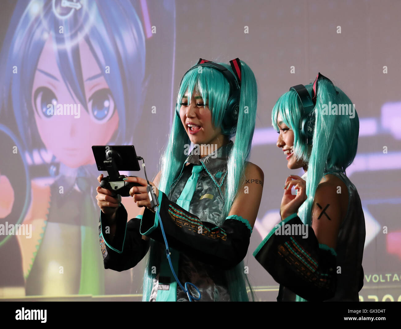 Thursday. 15th Sep, 2016. Models in costume of Hatsune Miku plays videogame with Sony's Xperia smartphone at the annual Tokyo Game Show in Chiba, suburban Tokyo on Thursday, September 15, 2016. The 20th anniversary Show includes show a new Virtual Reality (VR) area. The event hosts 614 exhibitors from 37 different countries and runs from September 15 to 18 at the International Convention Complex Makuhari Messe in Chiba. 1,523 game titles for smartphones, games consoles, PC and VR platforms are on show. Credit:  Yoshio Tsunoda/AFLO/Alamy Live News Stock Photo