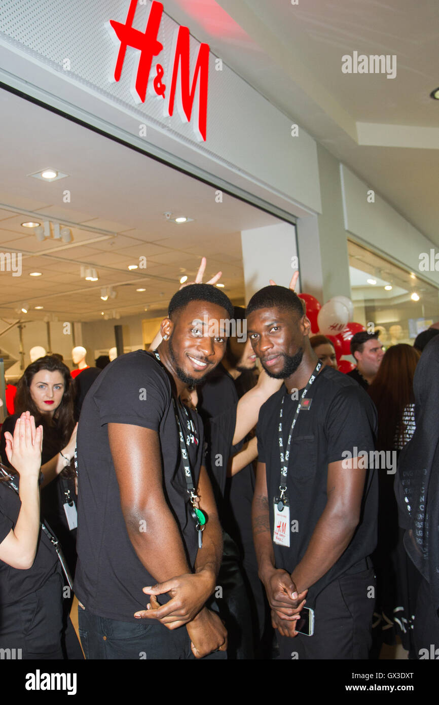 London, UK. 15th September 2016. H&M staff (l-r) Daniel and Katio outside  the new H&M store opening in Ilford. Ilford residents and visitors queue up  as a new H&M store opens its