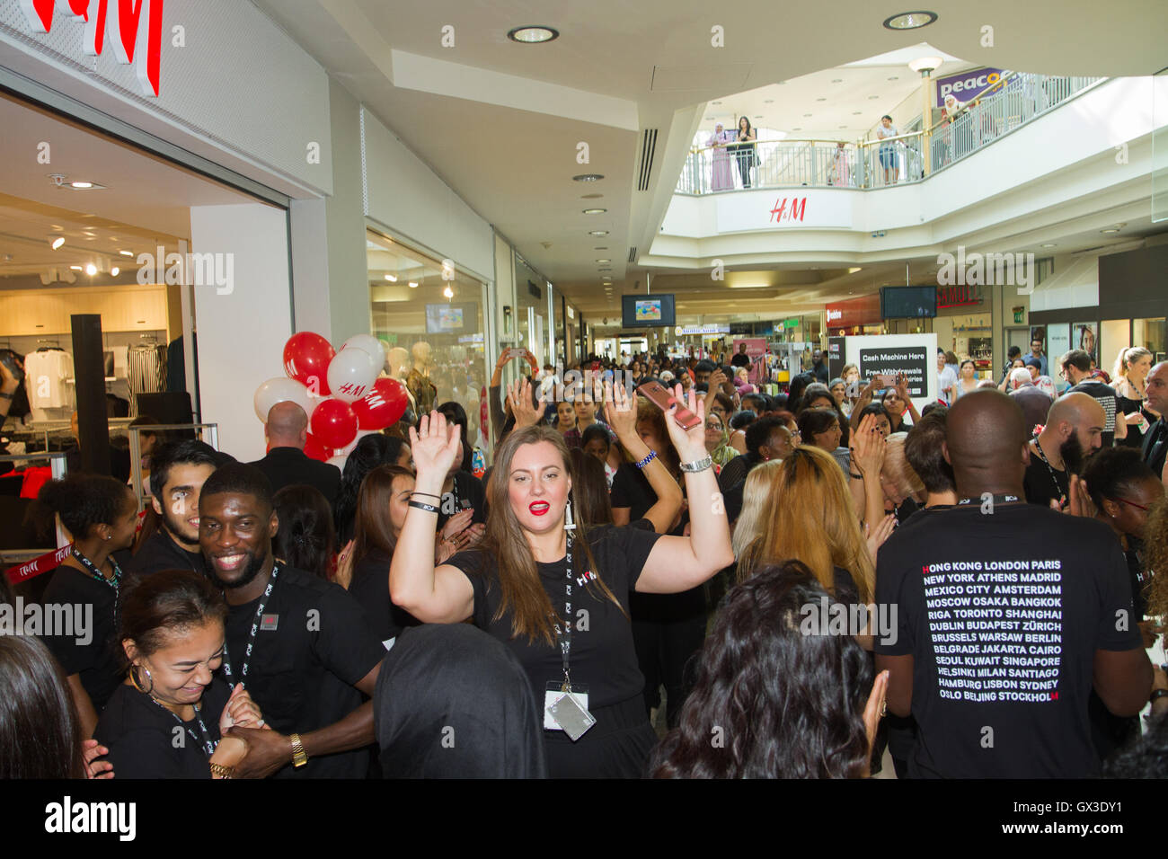 London, UK. 15th September 2016. H&M staff get ready to welcome Ilford  residents and visitors queueing up as a new H&M store opens its doors in  Exchange Mall Ilford in Essex. Customers