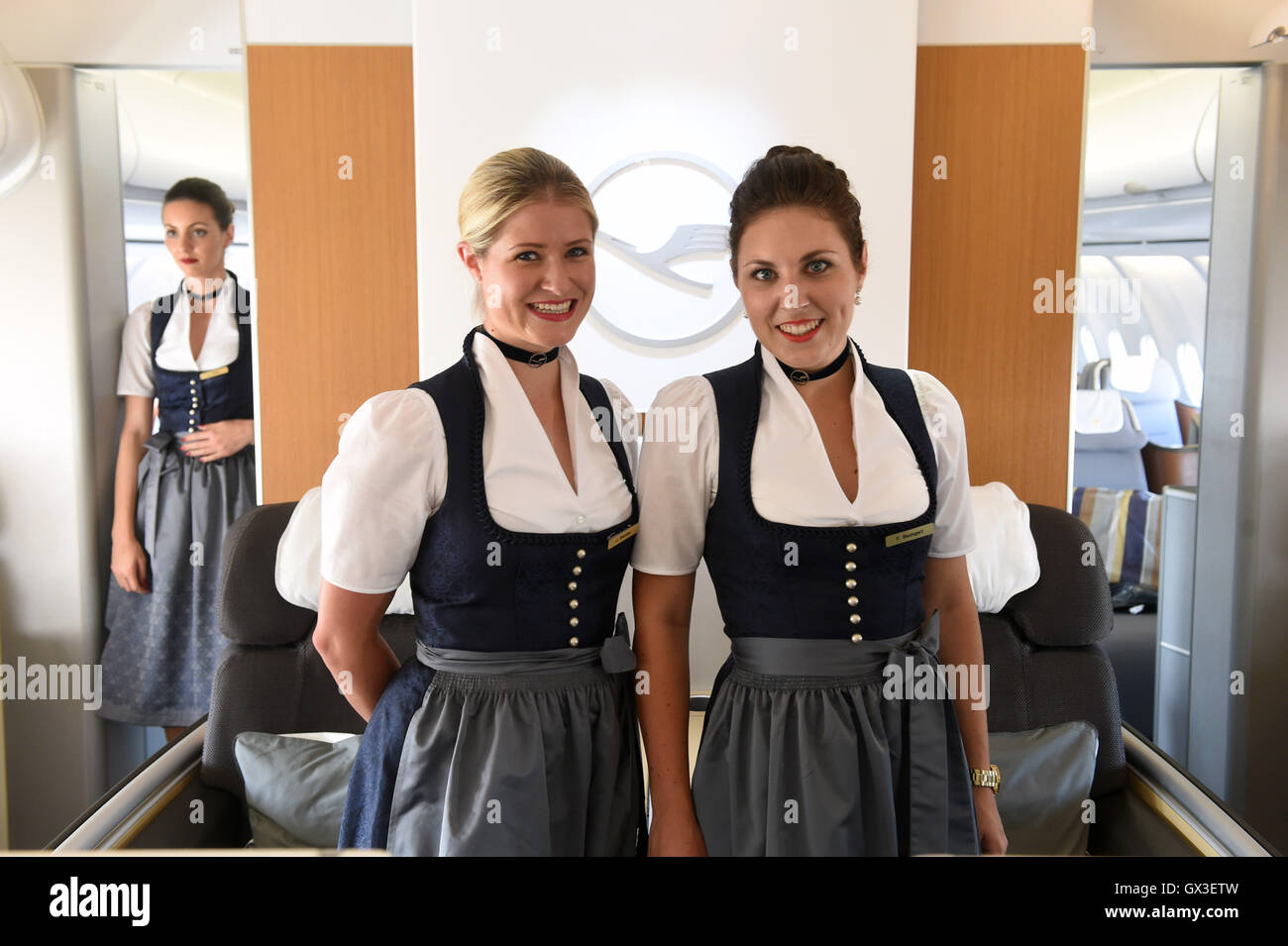 Munich, Germany. 15th Sep, 2016. Ladies from the Lufthansa Dirndlcrew pose in the 1st class area of a plane at the airport in Munich, Germany, 15 September 2016. This year's ladys' Bavarian Dirndl dresses and men's traditional costumes were presented to the public for the first time before their departure to Washington and Toronto. The airline has been sending out some employees in traditional dress during the Oktoberfest for 10 years. PHOTO: FELIX HOERHAGER/DPA/Alamy Live News Stock Photo
