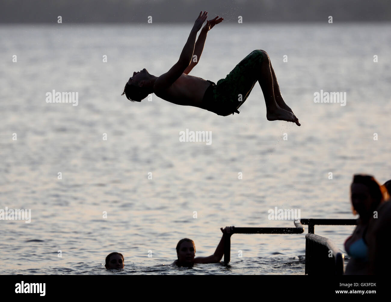Leipzig, Germany. 14th Sep, 2016. A young man jumping into the Cospudener See lake in Leipzig, Germany, 14 September 2016. PHOTO: JAN WOITAS/DPA/Alamy Live News Stock Photo