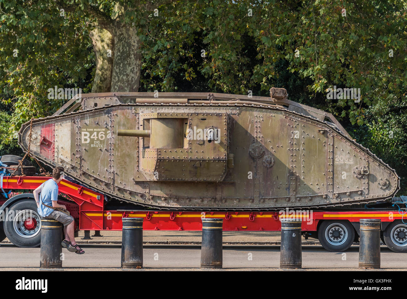 London, UK. 15th September, 2016. The tank is brought to Horse Guards Parade on a transporter on the short ride from Admiralty Arch to avoid damage to the road, here passing the memorial to the members of the Household Division - A replica of a World War One tank brought to London to mark the 100th anniversary its first use in action in the Battle of the Somme on 15 September 1916. Dorset's Tank Museum, provided the machine which was designed to travel at walking pace (3mph) to support the infantry. Credit:  Guy Bell/Alamy Live News Stock Photo