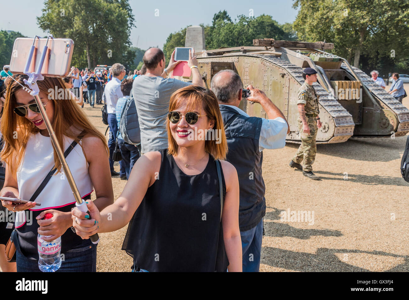 London, UK. 15th September, 2016. The tank arrives on Horse Guards Parade  where tourists take selfies and it  meets its contemporary sister, a Challenger tank of the Royal Tank Regiment - A replica of a World War One tank brought to London to mark the 100th anniversary its first use in action in the Battle of the Somme on 15 September 1916. Dorset's Tank Museum, provided the machine which was designed to travel at walking pace (3mph) to support the infantry. Credit:  Guy Bell/Alamy Live News Stock Photo