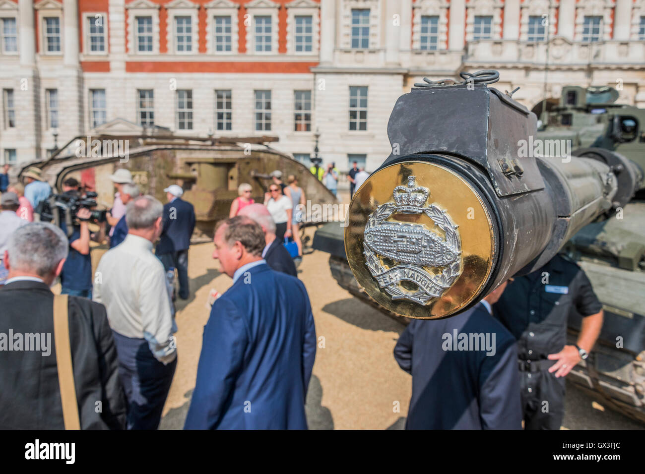 London, UK. 15th September, 2016. The tank arrives on Horse Guards Parade  where tourists take selfies and it  meets its contemporary sister, a Challenger tank of the Royal Tank Regiment (the end of its barrel with regimental crest in the foreground) - A replica of a World War One tank brought to London to mark the 100th anniversary its first use in action in the Battle of the Somme on 15 September 1916. Dorset's Tank Museum, provided the machine which was designed to travel at walking pace (3mph) to support the infantry. Credit:  Guy Bell/Alamy Live News Stock Photo