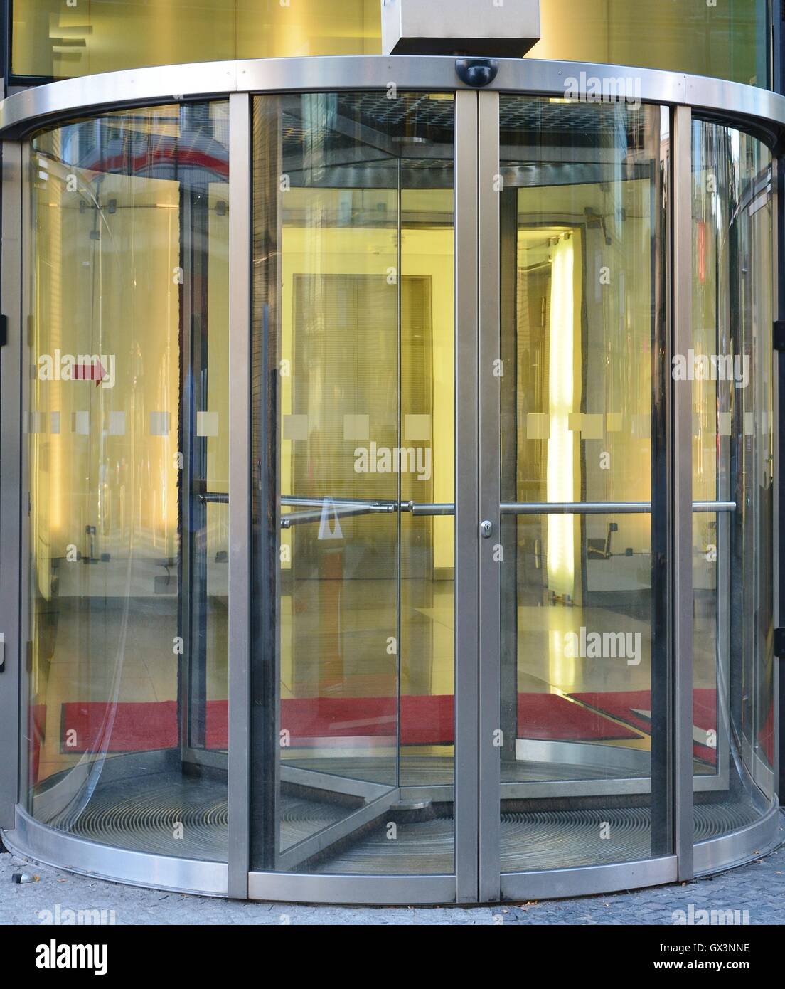 Modern revolving door as entrance to office building or hotel Stock Photo