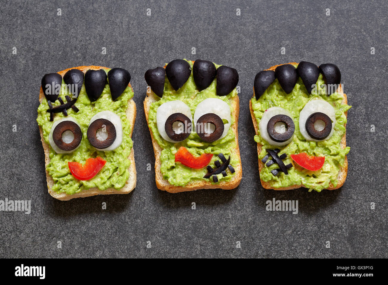 Avocado toast look like as green monster for Halloween Stock Photo