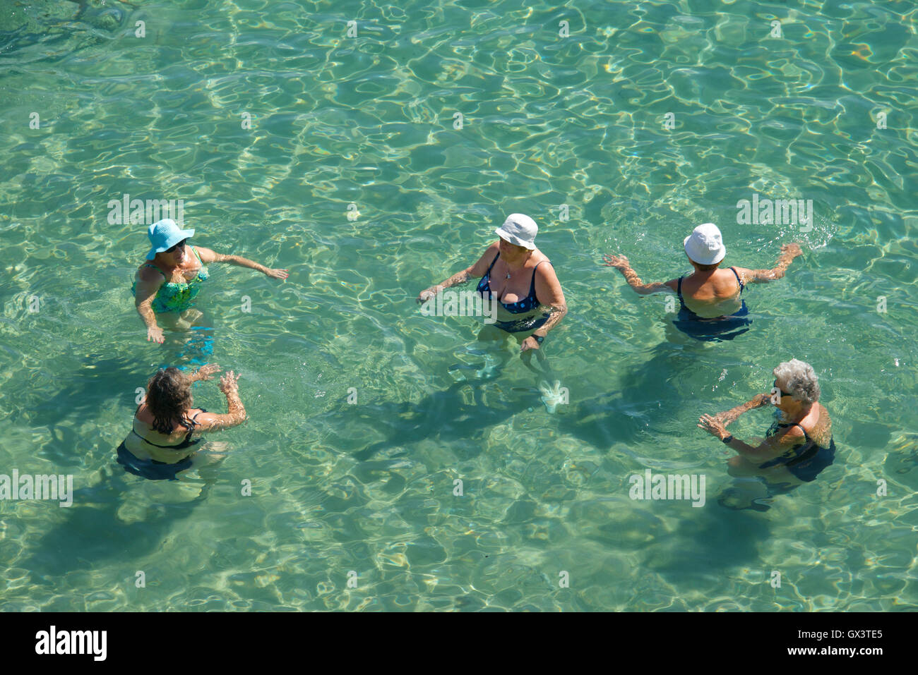 Top shot five women swimming Faliraki Beach Corfu Old Town Ionian Islands Greece Stock Photo