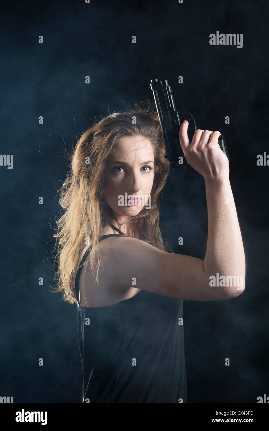 Angry woman holding a gun Stock Photo