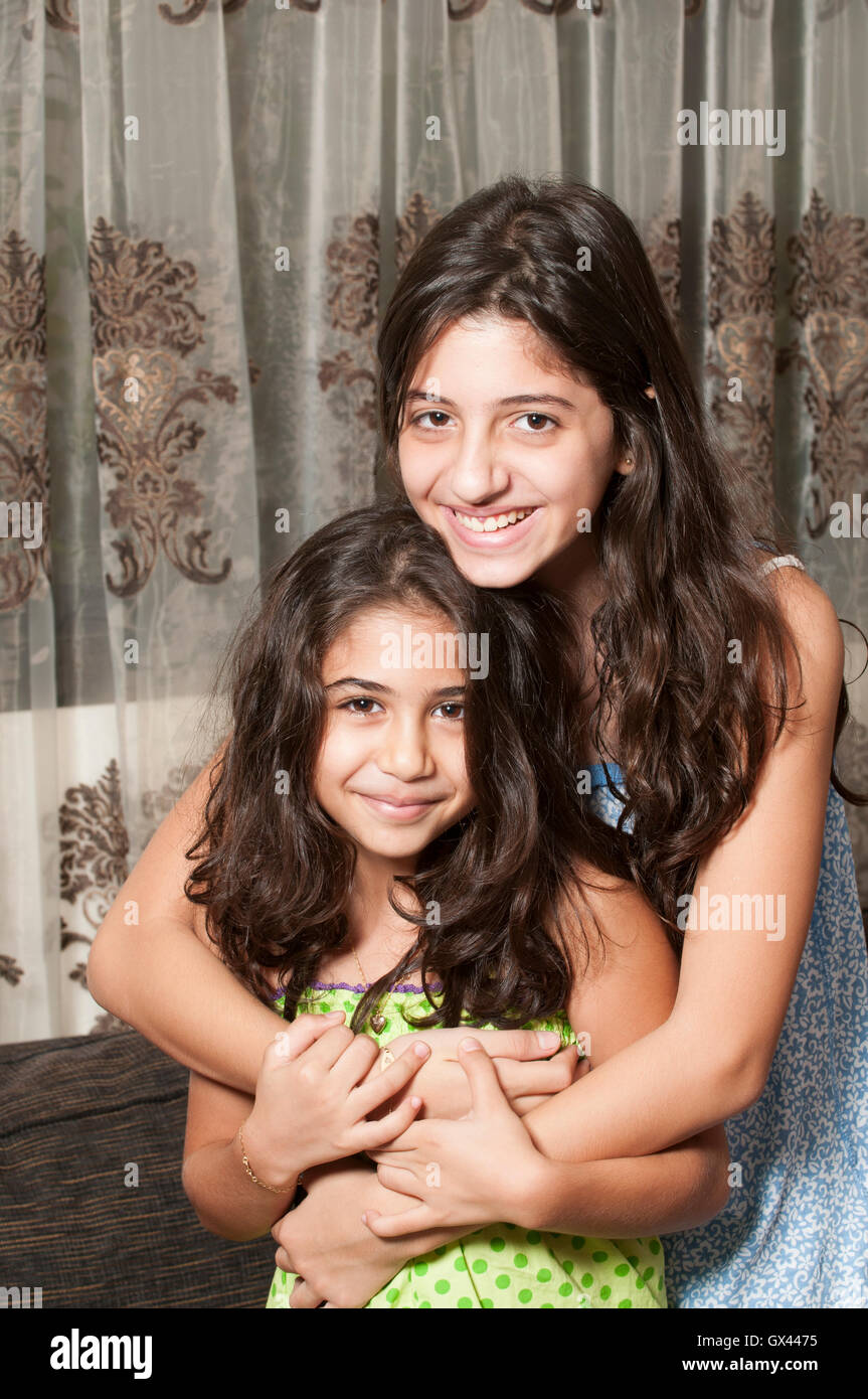 Happy sisters hugging Stock Photo