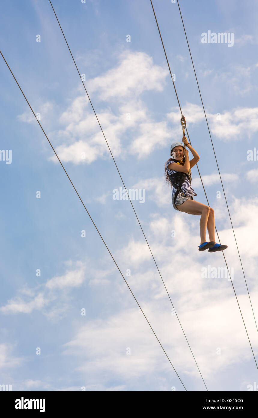 A zip wire rider makes the descent at Bournemouth, Dorset, UK. Stock Photo