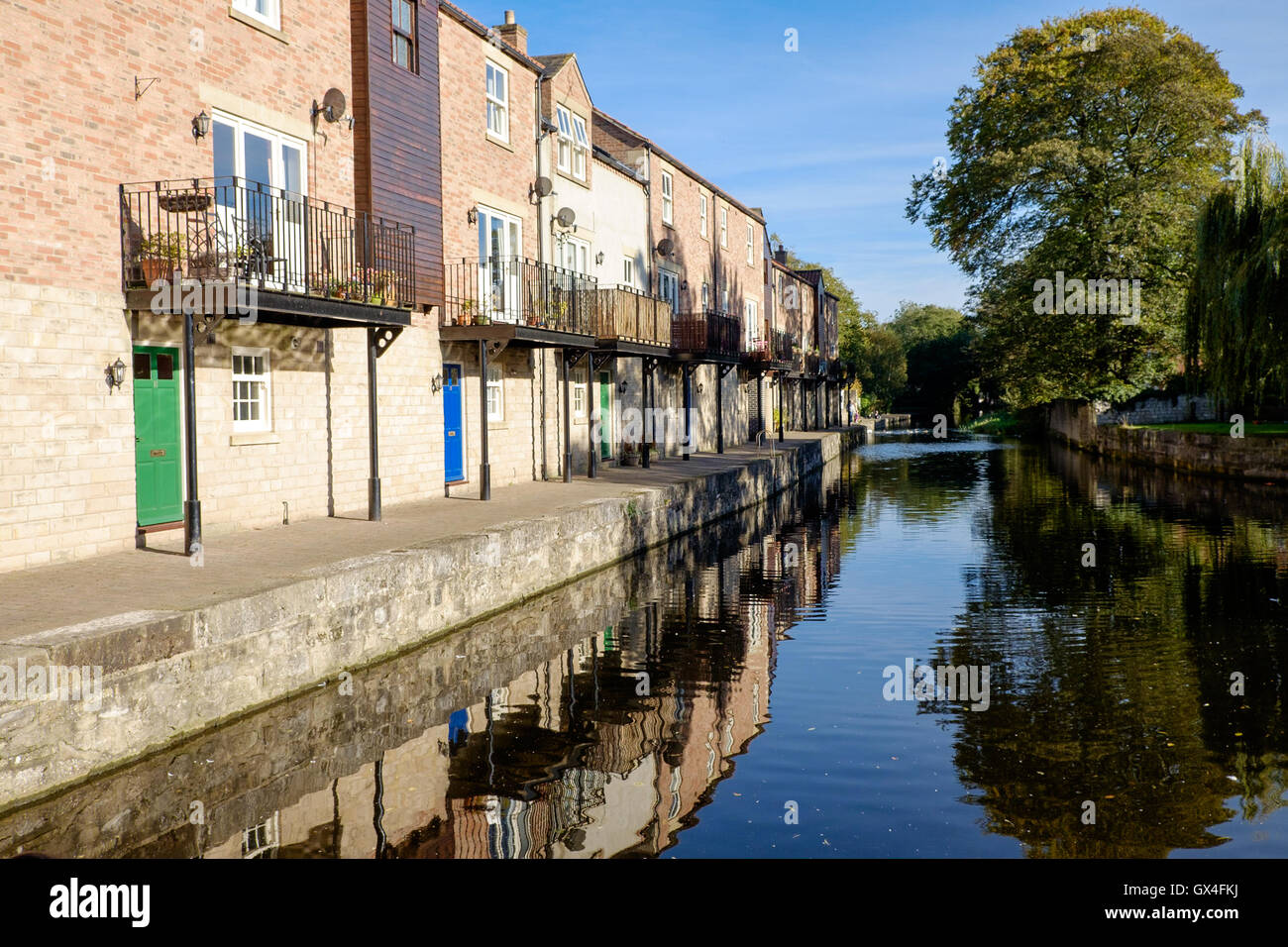 Buildings reflected in the Ripon Canal, Ripon North Yorkshire England Stock Photo