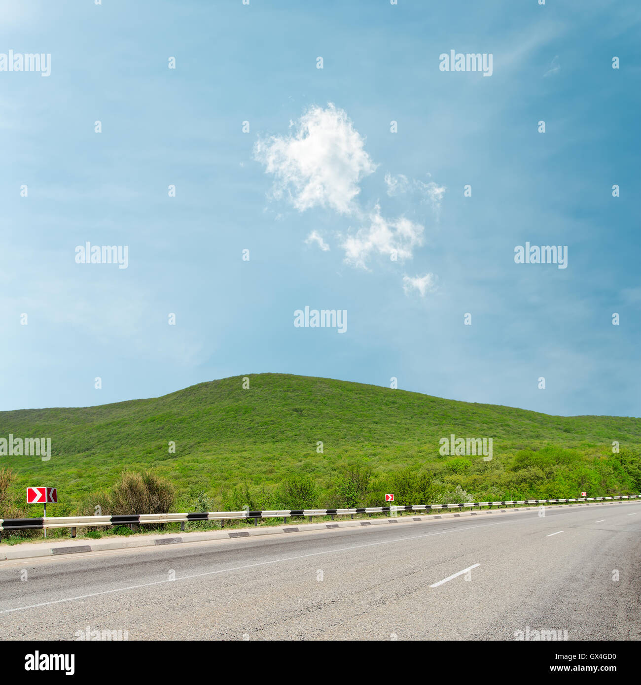 asphalt road to horizon in mountain under light clouds Stock Photo - Alamy