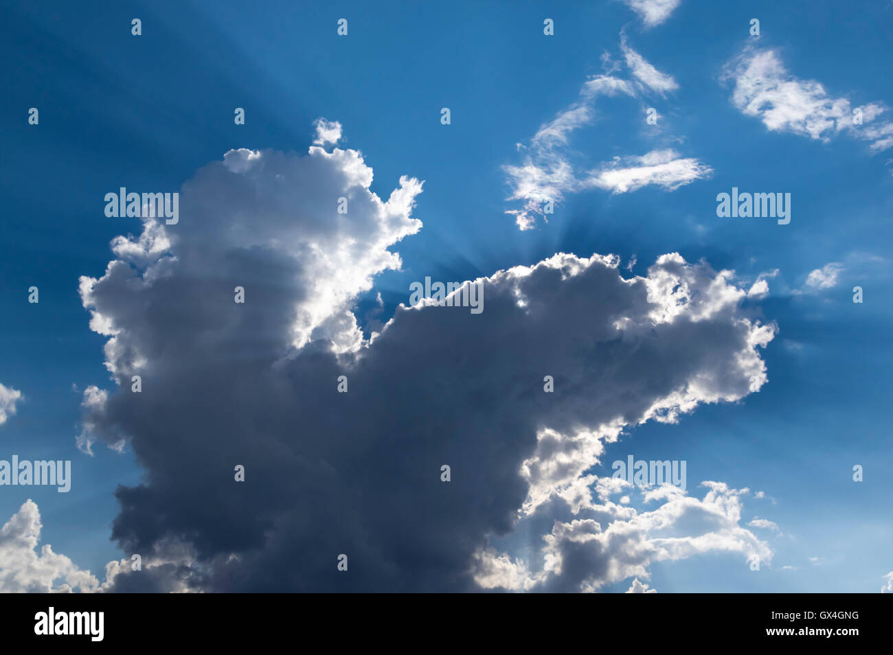 Cloud backlit by the sun, with sun rays clearly visible. Stock Photo