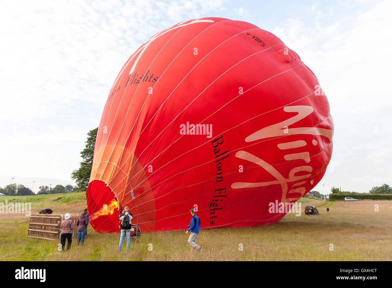 Red Virgin hot air balloon being inflated Stock Photo