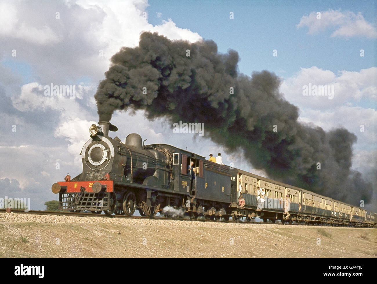 A Pakistan Railways SPS Class inside-cyclinder 4-4-0 heads away from Malakwal with cross-country passenger train in January 1977 Stock Photo