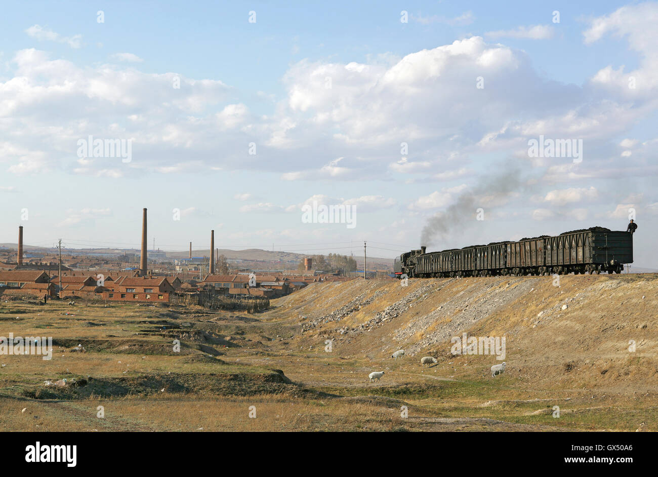 A Chinese SY 2-8-2 propells a loaded train up to the power station at Jalainur, May 2009. Stock Photo