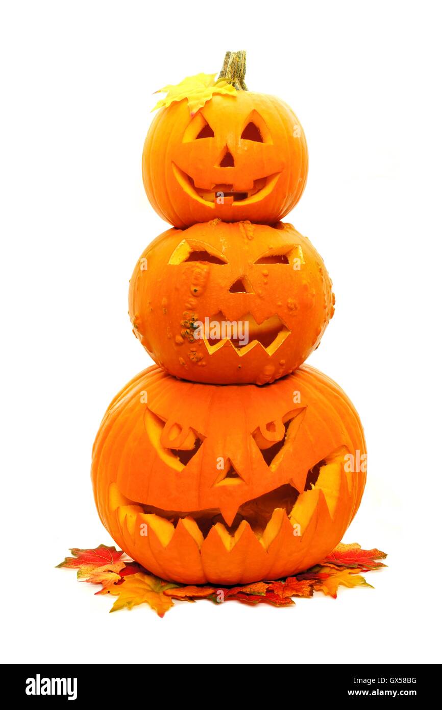 Group of three stacked Halloween Jack o Lanterns with autumn leaves ...