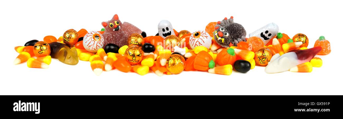Long border of assorted Halloween candy over white Stock Photo